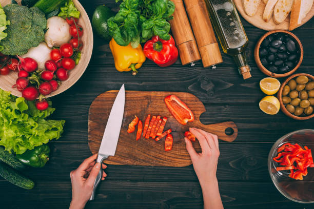 istock hands holding sliced peper and knife 882424988