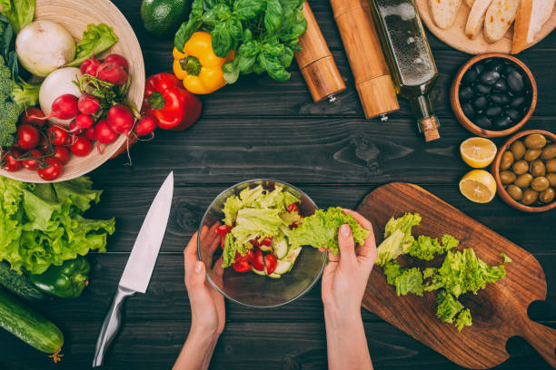 istock hands holding bowl with salad leaves 882430076