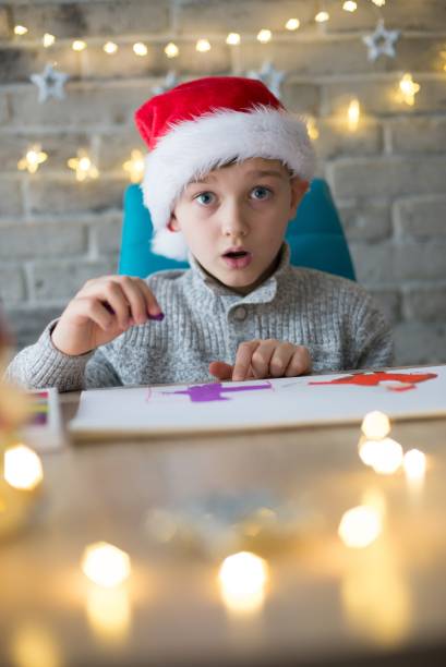 istock Shocked boy in Santa Claus cap 882430316