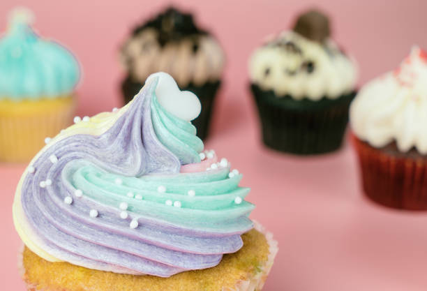 istock Top of Rainbow cupcake with mini cupcakes on background 882430654