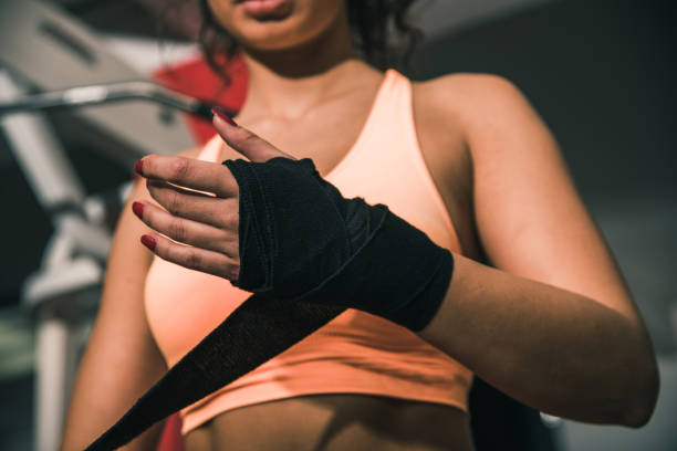 istock Sportswoman wrapping her hand 882430834