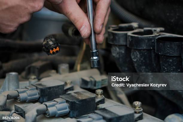 Car Engine Repair Replacing The Spark Plugs In The Engine Repair Of The Old Machine Stock Photo - Download Image Now