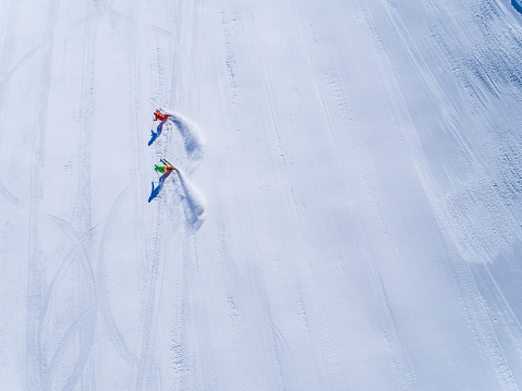 Winter Breaks - aerial view two skiers skiing