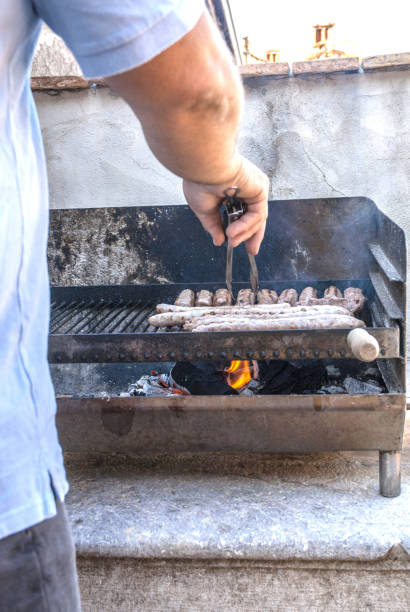 Man Grilling Meat on the Barbecue