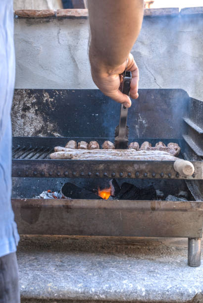 Man Grilling Meat on the Barbecue