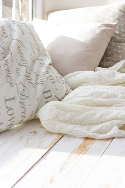 istock cushions and a knitted plaid on the windowsill. 882441112