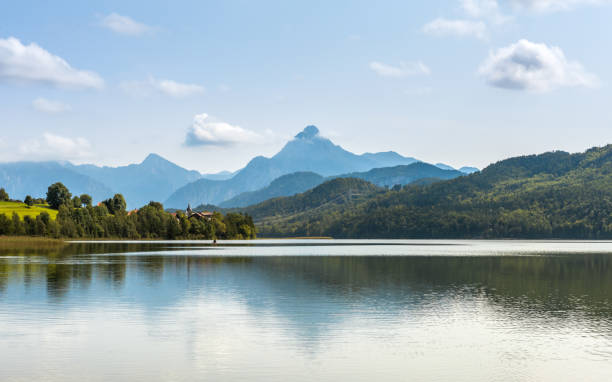 istock Green water Weissensee lake in Alps Mountains 882444930
