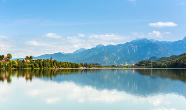 istock Green water Weissensee lake in Alps Mountains 882445128