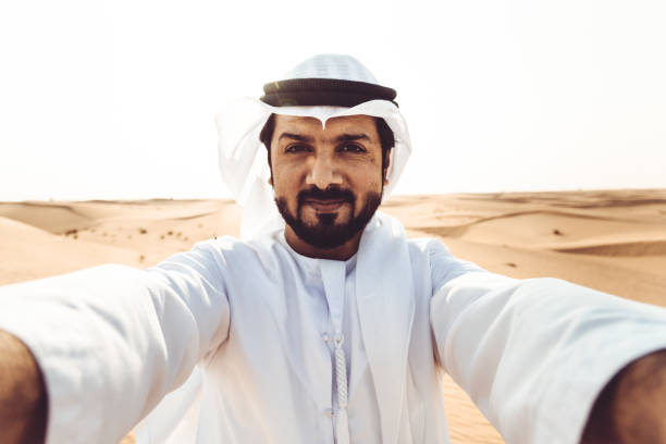 istock arabic man take a selfie in the desert 882448046