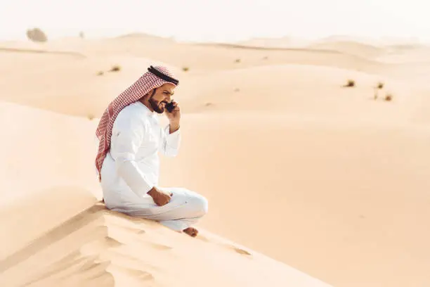 arabic man on the phone in the desert