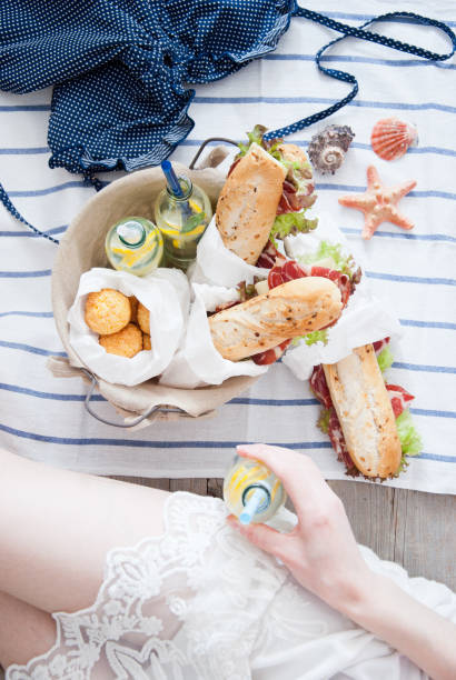 istock Picnic ham sandwiches and lemonade in a basket 882460898