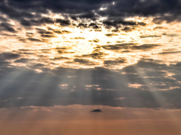 istock Sun rays breaking through cumulus clouds. Heavenly landscape 882463224