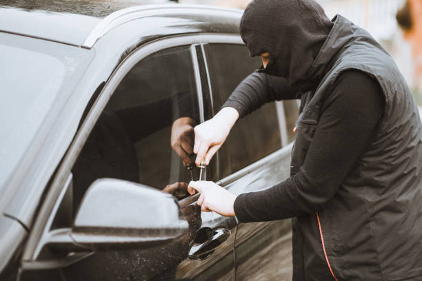istock Thief trying to break into the car with a screwdriver 882464088