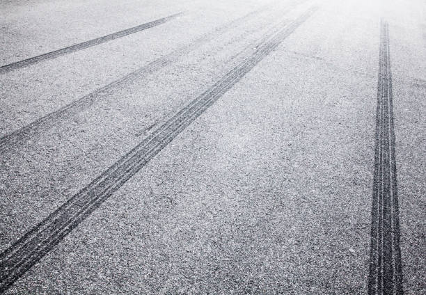 istock Wheel tracks on the road covered with hoarfrost 882465370