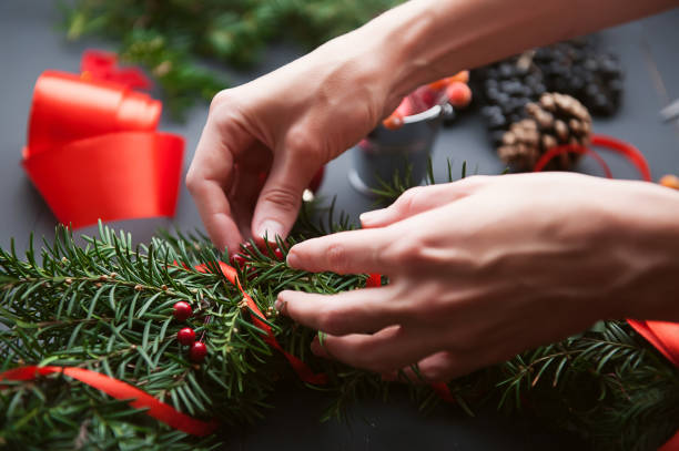 istock mom makes a Christmas wreath with her own hands 882468262