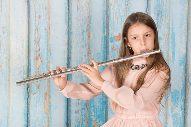 istock Girl playing a flute 882471158