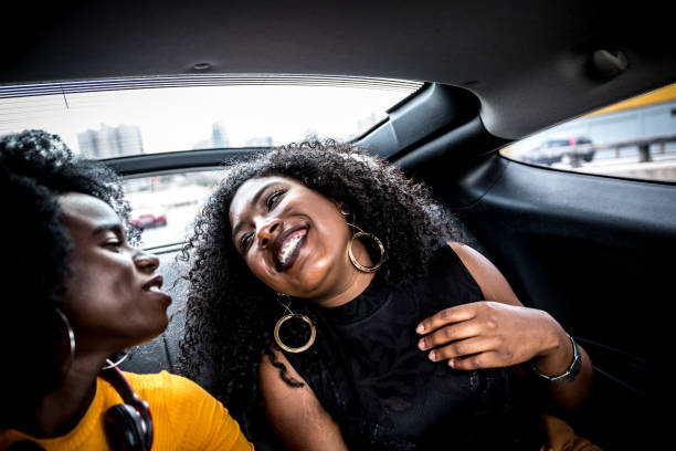 istock Afro girls having fun in the car 882471924