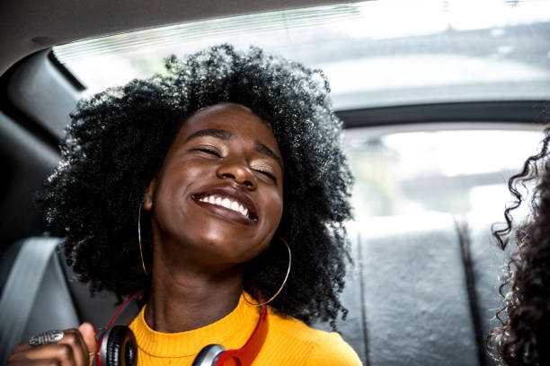 istock Afro girls having fun in the car 882472916