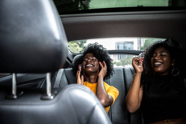 istock Afro girls having fun in the car 882473038