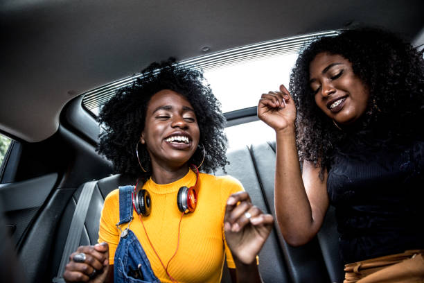 istock Afro girls having fun in the car 882473892