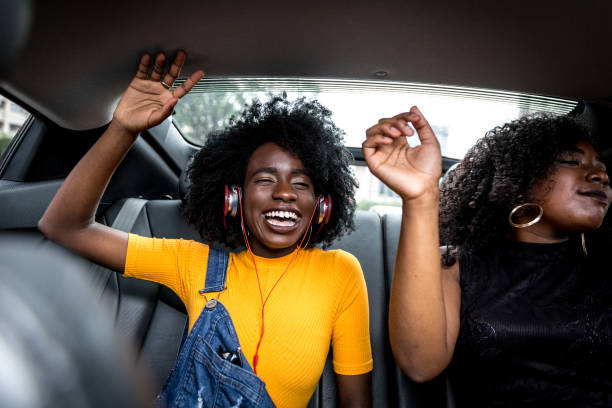 istock Afro girls having fun in the car 882473968