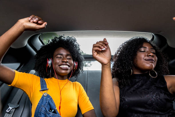 istock Afro girls having fun in the car 882473970
