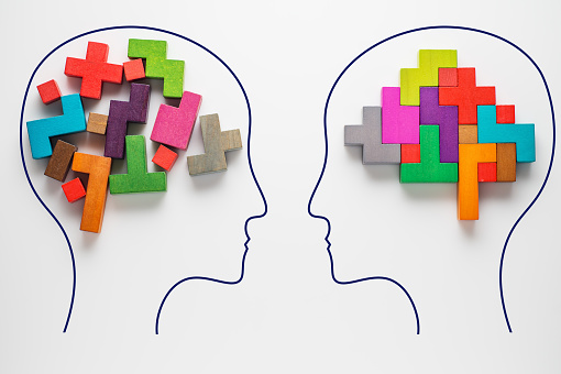 Heads of two people with colourful shapes of abstract brain
