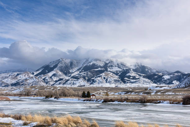 Frozen Yellowstone River in Winter Surrounded by Mountains stock photo