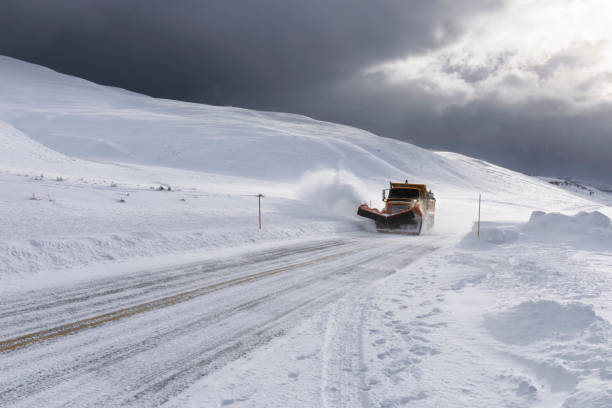 istock Snow Plow Clearing Roads during Snowstorm 882484606