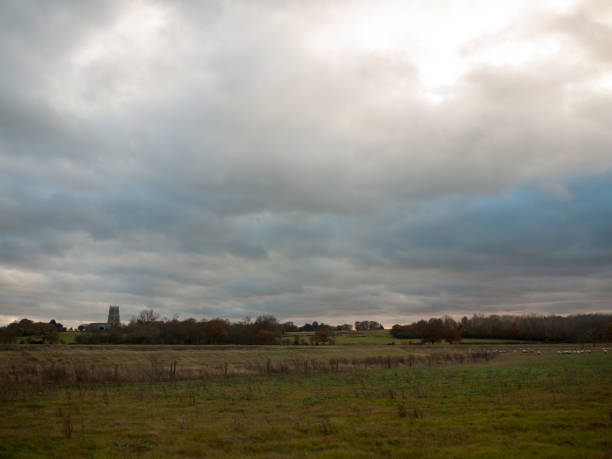 istock open grass land country field plain green white cloudy sky 882487944