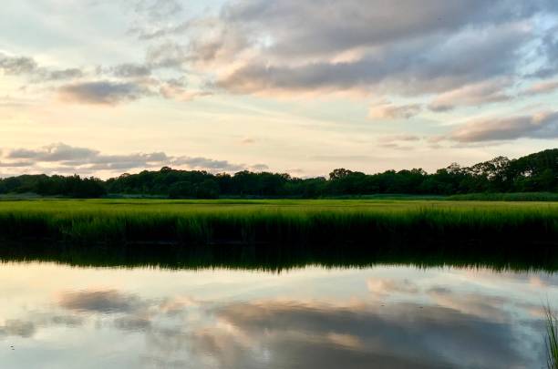 istock Beautiful evening sky and tranquil landscape reflecting in the water 882513332