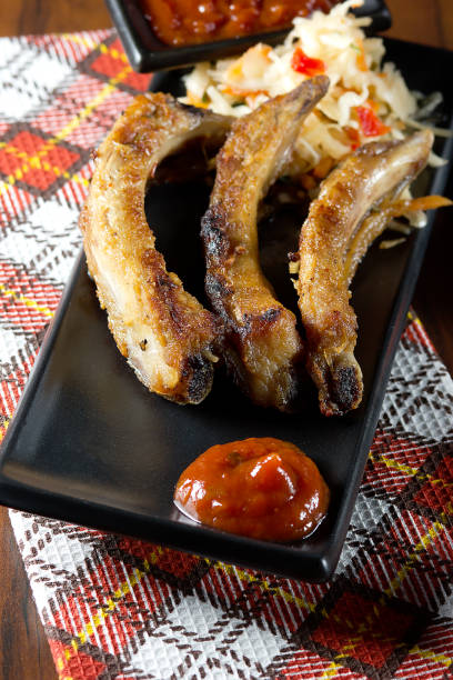 istock Pork ribs with cabbage salad and tomato sauce 882517260