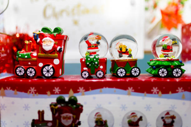 istock Christmas snow glove train ornaments on display in a shop window in the UK 882517536