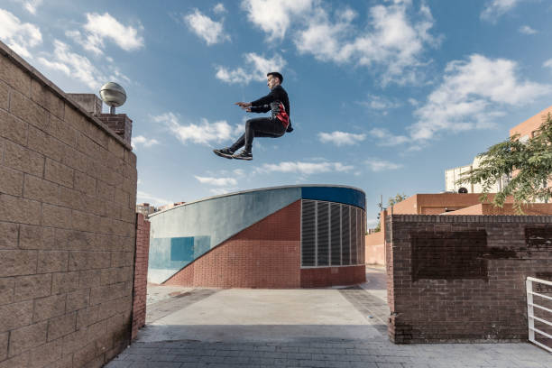 istock Man jumping during parkour practice in the city 882524288