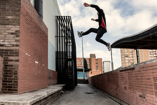 istock Man practicing parkour in city suburbia 882524290