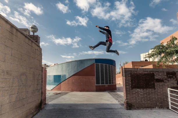 istock Man jumping during parkour practice in the city 882524310