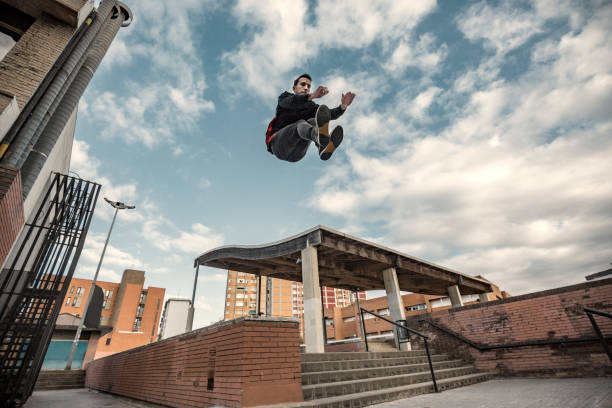 istock Man jumping during parkour practice in the city 882524328