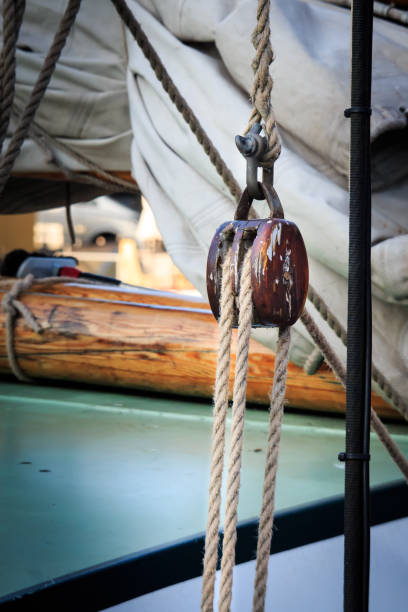 istock Wooden tackle with rope on a ship 882524732