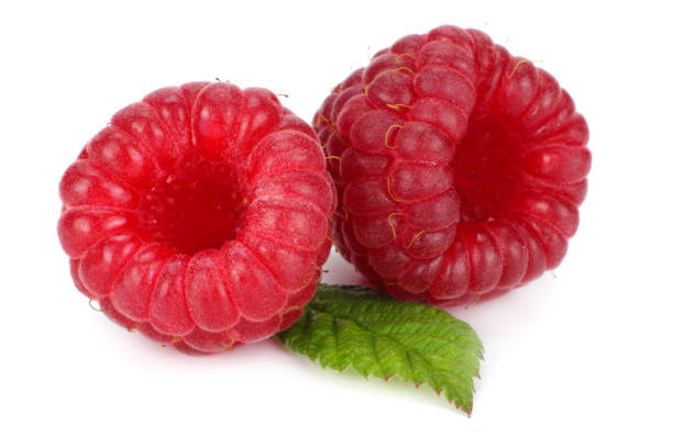 istock ripe raspberries with green leaf isolated on white background macro 882526724