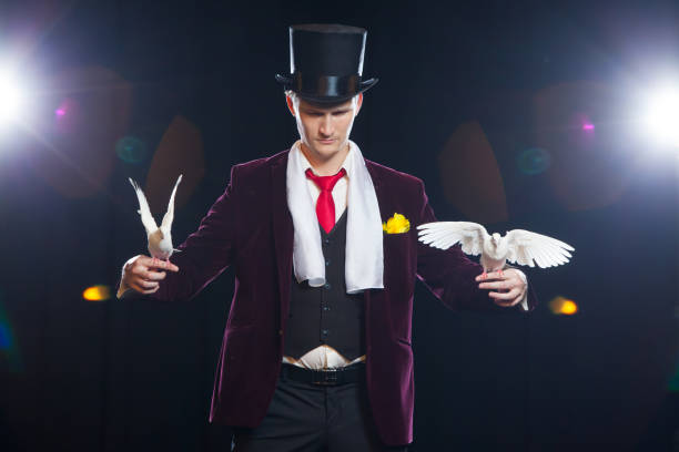 istock The magician with a two flying white Doves. on a black background 882527878