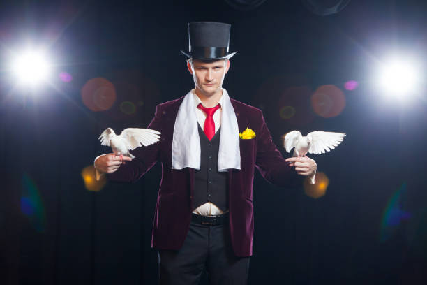 istock The magician with a two flying white Doves. on a black background 882527922