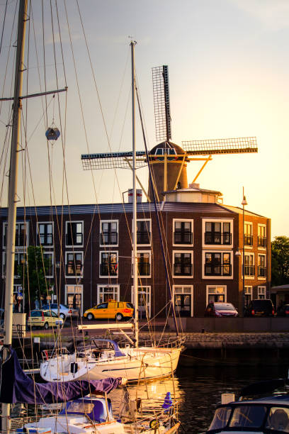 istock Traditional windmill and harbor in the evening light 882537232