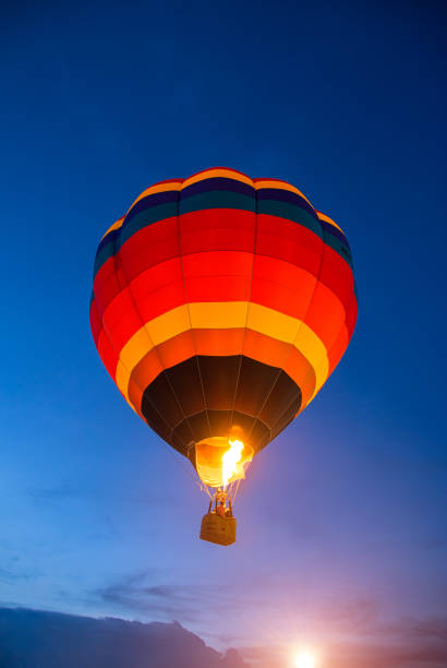 istock Colorful hot air balloon is flying at sunset 882538784