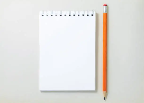 Top view of open spiral blank notebook on white background