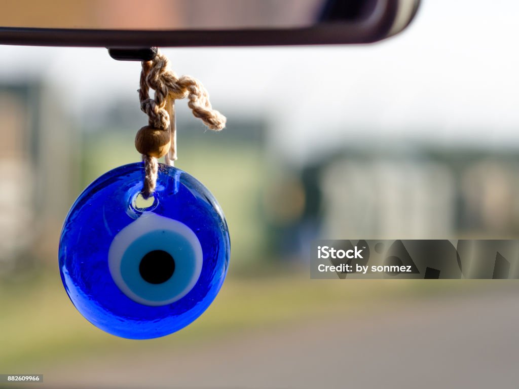 evil eye beads hanging from the rearview mirror (Turkish tradition) Eye Stock Photo