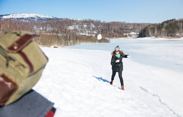 istock Couple snowball fighting and having fun 882631068