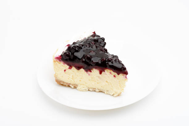 istock A slice of  blue berry cheesecake on white background. 882649024