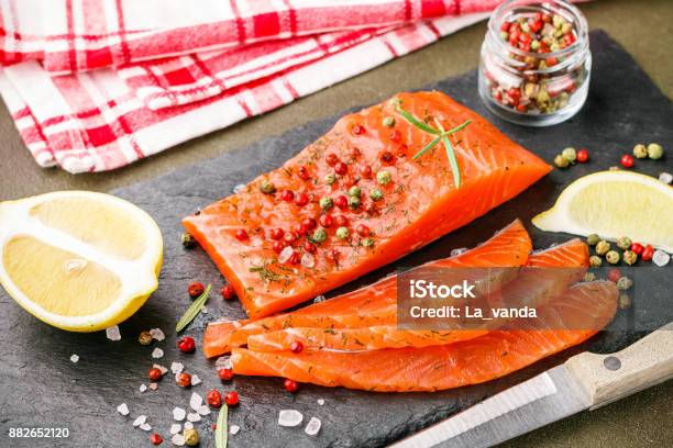 Gourmet Sliced Salted Salmon With Pink And Green Peppercorn Lemon And Dill Fish Seafood Snack For Gourmets Selective Focus Stock Photo - Download Image Now