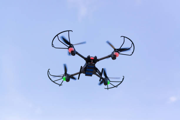 istock Flying drone of quad copter in blue sky. 882652230