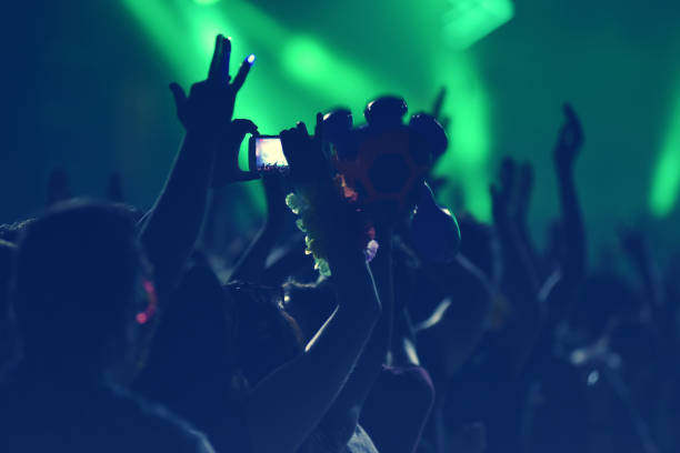 istock Crowd with arms outstretched at concert 882652606